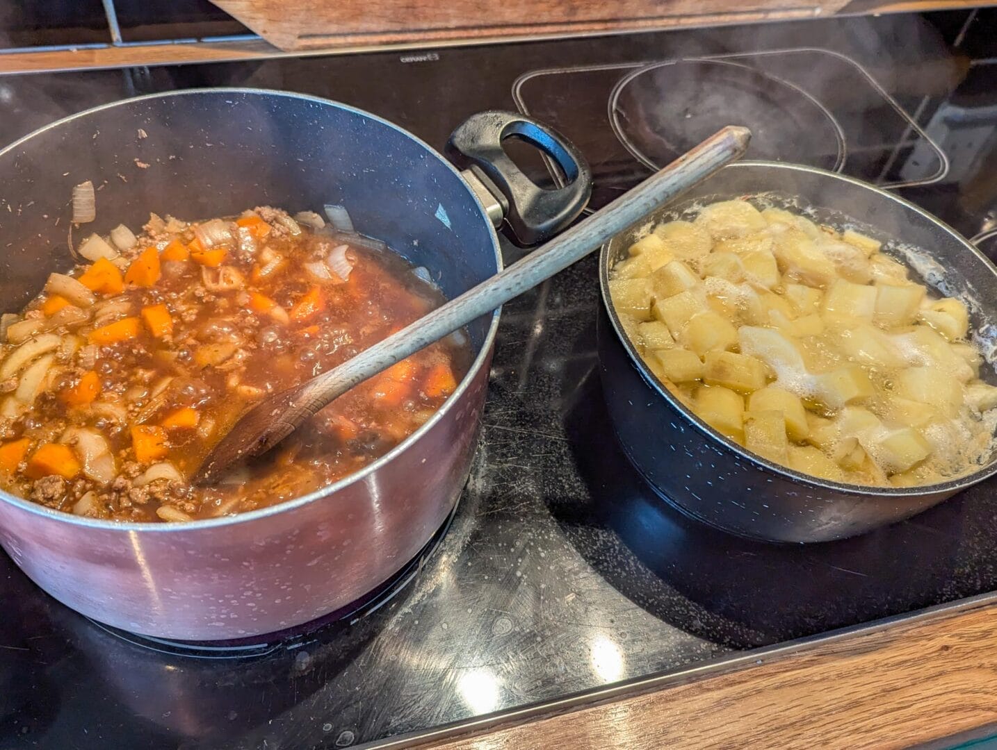 two pots with food on a stove